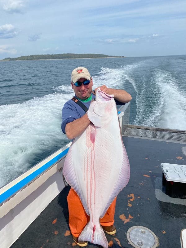 Michael Cushman of Port Clyde Fishermen's Coop on F/V Ryleefinn with a big, beautiful halibut