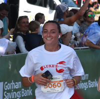Rosie Train smiling while running a race wearing a Luke's shirt