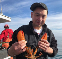 Thanh Le holding up a lobster