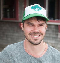 Ben Conniff, cofounder, smiling and wearing a white and green hat