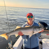 Woman holding a fish on boat