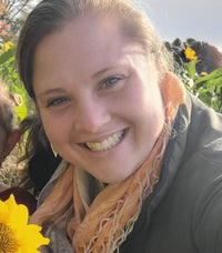 woman smiling in a sunflower field