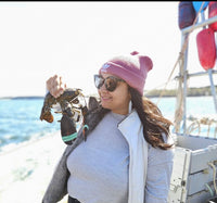 Maria holding a lobster on a boat