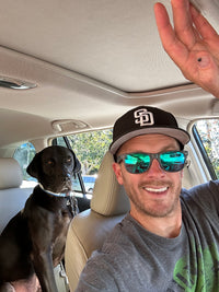 Trevor taking a selfie with his dog in the backseat of the car