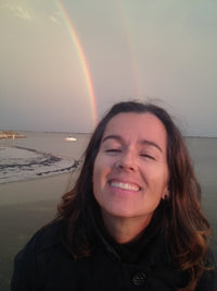 Raina Stefani; smiling for a selfie on the beach 