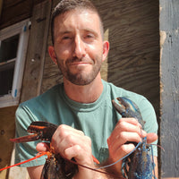 Frank taking a selfie while holding two lobsters