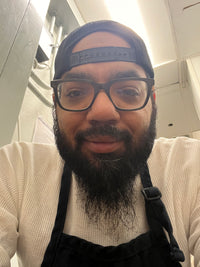 Roscoe; man with beard, glasses, and a hat smiling for a selfie