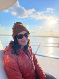 woman smiling on a boat on the ocean
