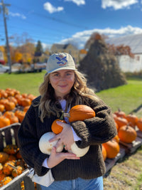 Julia holding pumpkins while posing for a picture