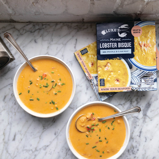 Lobster bisque in bowls on marble grey countertop