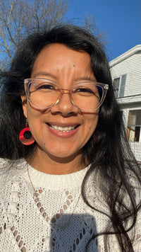 Susan wearing a white sweater posing for a selfie