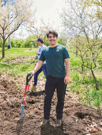 Imer Huertas; a man holding a shovel while doing landscaping