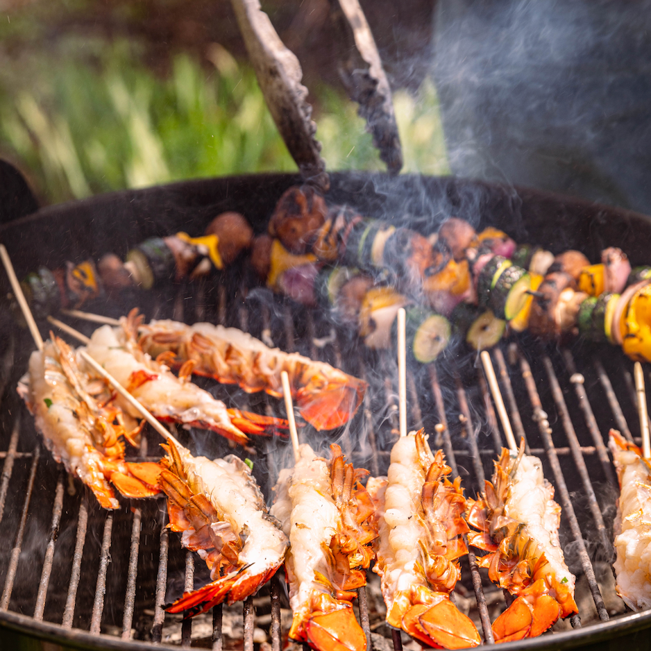 Load image into Gallery viewer, Split lobster tails on grill
